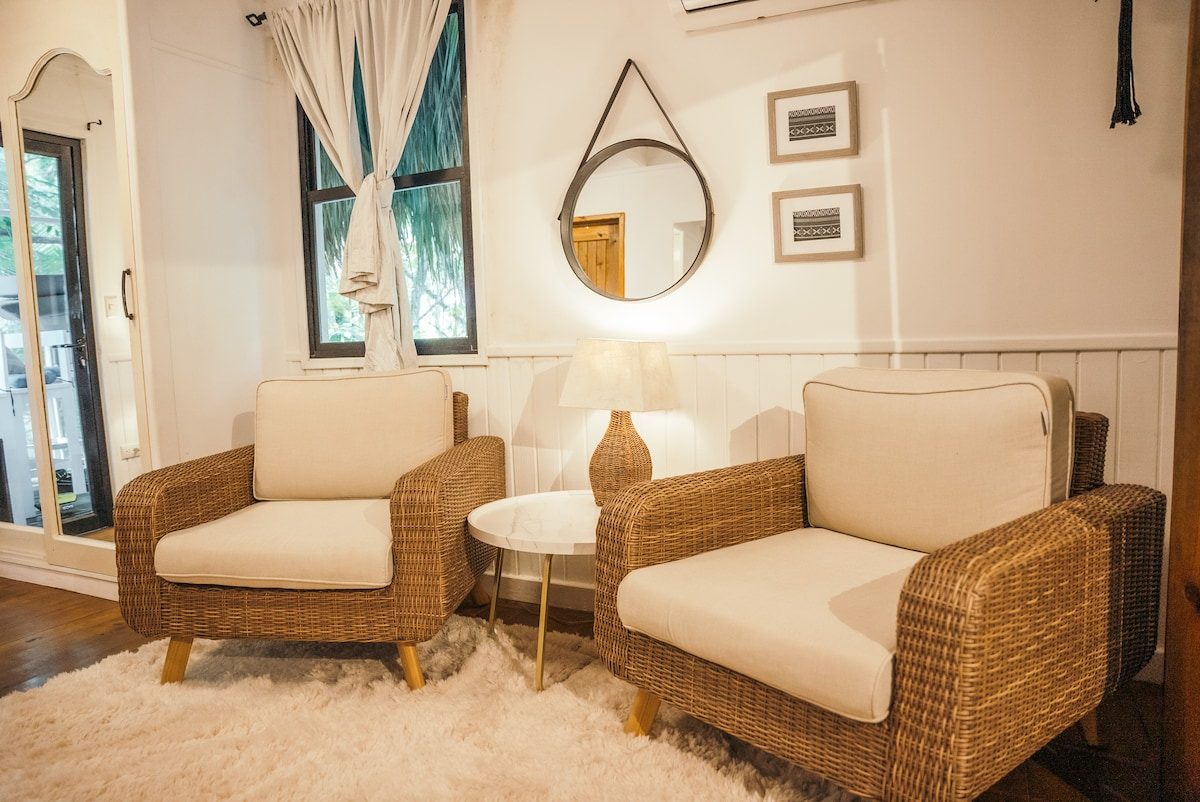 Junior Suite sitting area with two wicker chairs